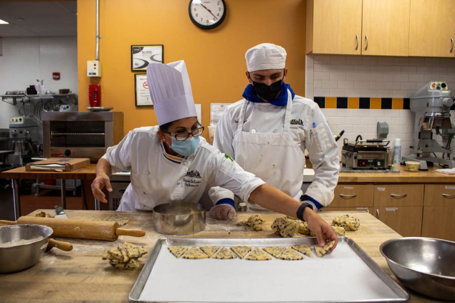 Chef DeLustro (left) is preparing cookies with Baking and Pastry Arts Majors. Sam Meyer, (right) is being taught by Chef DeLustro how to cut and prepare the cookies for them to be put in the oven at the Bakers Workshop in Riverhead on Weds. Oct. 5, 2021.