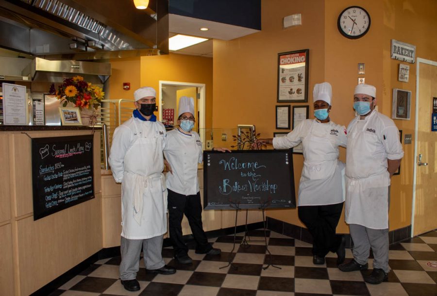 (Left to right) Sam Meyer, Chef DeLustro, Kassie Watson, and Andrew Nieces gather around for a picture at the front of the Bakery for the reopening this semester at The Bakers Workshop in Riverhead on Weds. Oct, 5, 2021. 