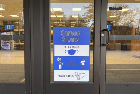 A safety sign is hung up on the outside of the Brookhaven Gymnasium on March 25, 2022. The sign reminds students to stay safe by wearing their masks, washing their hands, and staying socially distant. 