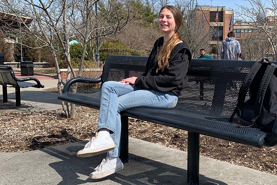 Ella Arancio, 18, of Bayport, enjoys a sunny day in Veterans Plaza on March 15, 2022. Arancio, a general studies major, is looking forward to sleeping in and spending time with friends over spring break. 
