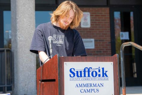 Kai Helenius, 18, of Mastic Beach, reads at the LGBTQ+ Banned Book read-out on the Ammerman campus on Wednesday, April 20, 2022. According to a report by PEN America, 1,586 books with topics about the LGBTQ+ community, comprehensive sexual education, race and racism have been banned in school districts across the United States in the last nine months. 
