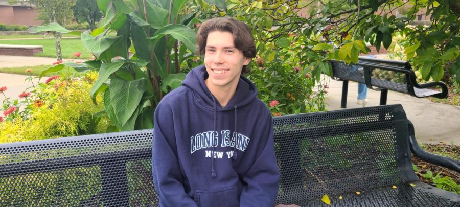 Patrick Adams, 17, of Selden, smiles in-between classes on a bench in the quad on the Ammerman campus. Adams, an education major, recalls the one of the greatest memories of his summer to be a concert he went to with his older brother at Citi Field earlier this summer.  