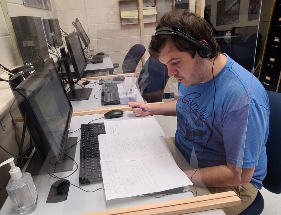 Joseph Lombardo, 25, of Centereach, goes over lesson plans for his next student at his desk in the basement of the Huntington Library on Nov. 1, 2022. Lombardo has been a math tutor for student support services for six years. 
 
 
 

