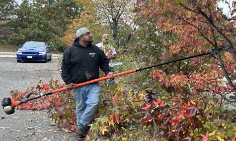 Jose Ramirez, 26, of Selden, cuts down trees in Parking Lot 7 on October 26, 2022. Ramirez has been an auto equipment operator on the Ammerman campus for four years. 