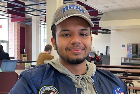 Ephrem Romao, 19, a liberal arts major from Shirley who is graduating, talks about his experience at Suffolk while relaxing in the Babylon Student Center cafeteria on March 15, 2023. (Compass News/James Quigley)