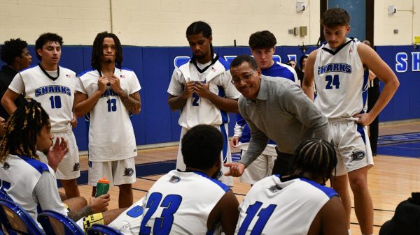 Mens basketball head coach Victor Correa   directs the team in a huddle during the season home opener at the Brookhaven Gymnasium on Nov. 9, 2023 (Compass News/Fran Tini)
