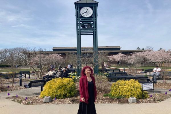 Leanne Warshauer, assistant academic chair of the English department, standing in front of the clock tower, the final spot of the poetry walk. (Compass News / Michael Melecio).