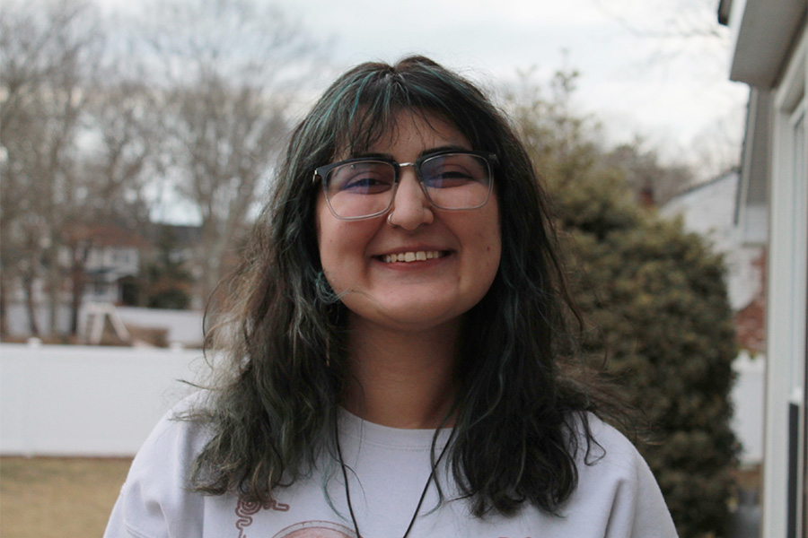 Charlotte Fritz, an artist who graduated from Suffolk in May 2024, smiles at her Port Jefferson Station residence on Saturday, March 1, 2025.