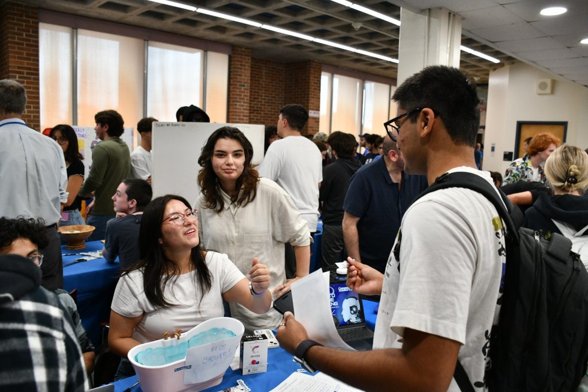 Katherine Quinche, 21, (left), a computer science major, interacts with a student about joining the Computer Science Club on Sept. 10, 2025. 