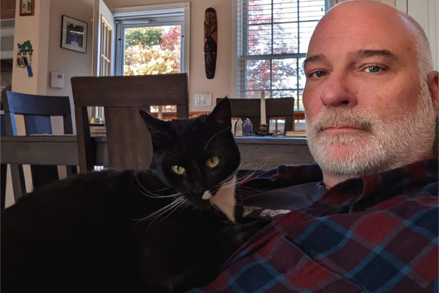 Matt Kindelmann, a 27-year Walt Whitman High School English teacher, with his cat, Athena. Kindelmann initially didn’t take to Suffolk, but eventually thrived and went on to SUNY Oneonta.